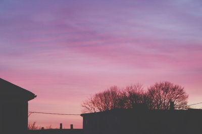 Low angle view of silhouette trees against sky during sunset