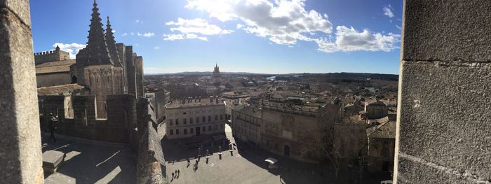 Panoramic view of buildings in town against sky