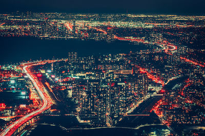 High angle view of illuminated buildings in city at night