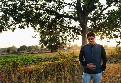 Portrait of young man standing on field