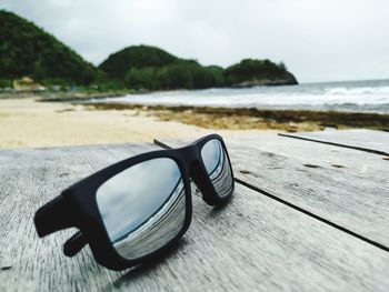 Close-up of sunglasses on table at beach