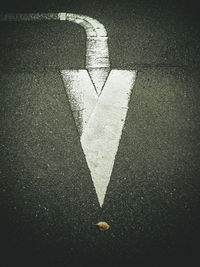 High angle view of arrow sign on road