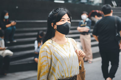 Woman standing on street in city