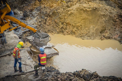 High angle view of men working on rock