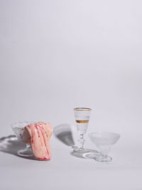 Meat in bowl with drinkware against white background