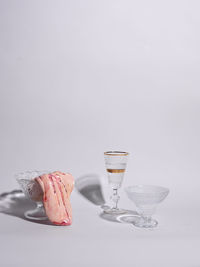 Close-up of wine glass on table against white background