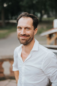 Portrait of smiling man standing outdoors