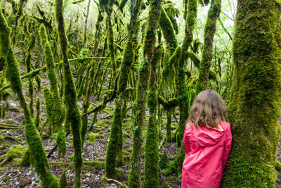 Girl in pink lost in a great terrifying forest of lianas