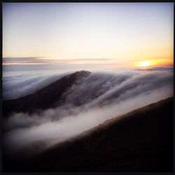 Scenic view of landscape against sky at sunset