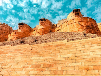 Low angle view of historical building against cloudy sky