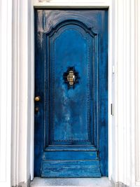 Closed blue door of old building