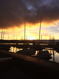 Boats in harbor at sunset