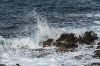 Waves splashing on rocks