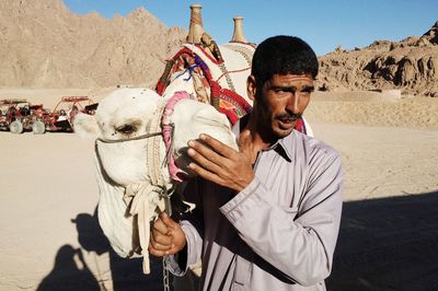 Man with camel at desert