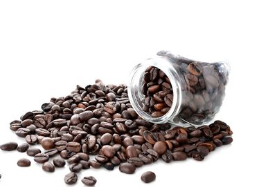 Close-up of coffee beans against white background