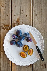 High angle view of fresh damson plums on a plate