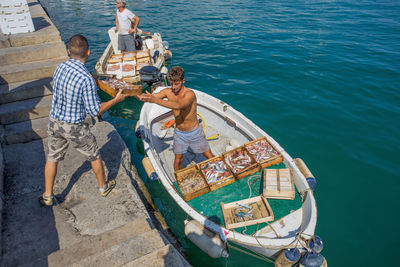 High angle view of people on boat in sea