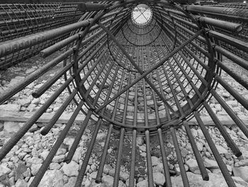 Rolled up metallic rods over stones at construction site