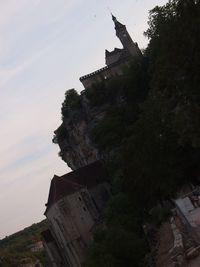 Low angle view of abandoned building against sky