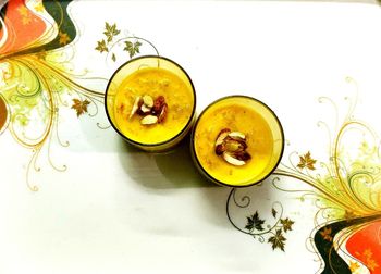 High angle view of drink on table against white background