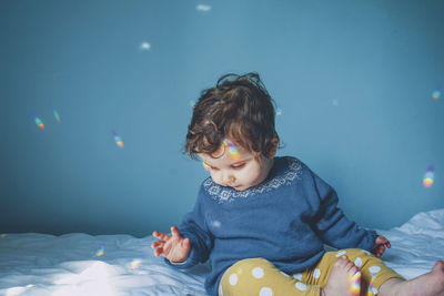 Cute baby girl on bed at home