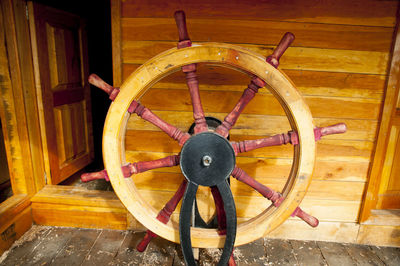 View of yellow wheel on wooden wall