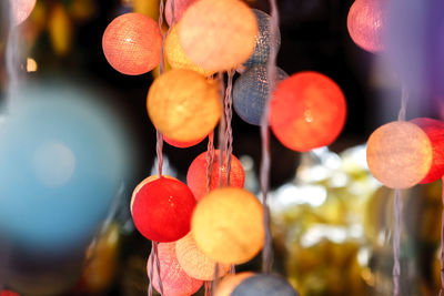 Close-up of fruits hanging against blurred background