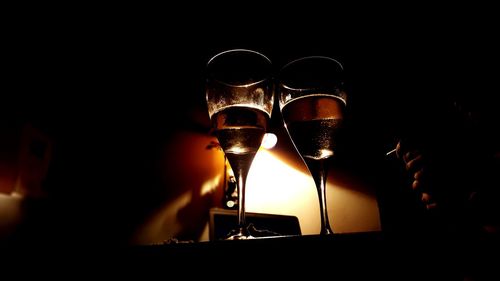 Close-up of wine glass against black background