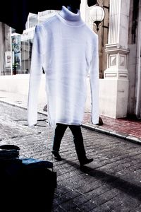 Rear view of man walking on street