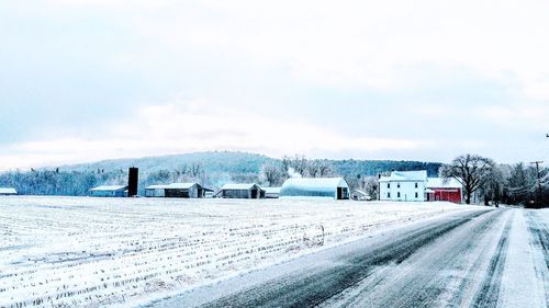 Snow covered road against sky