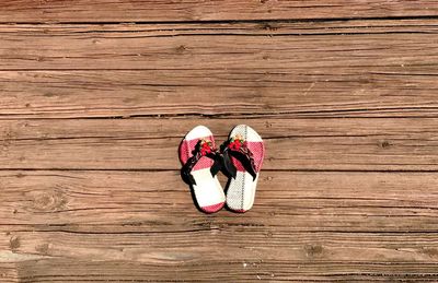 High angle view of pink shoes on wood