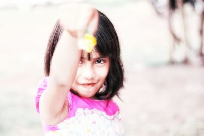 Portrait of girl holding flower