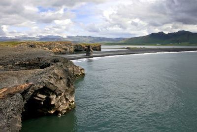 Scenic view of sea against cloudy sky