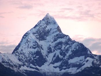 Scenic view of snowcapped mountains against sky during sunset