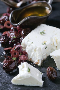 Close-up of black olives and feta cheese on table