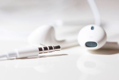 Close-up of in-ear headphones on white table
