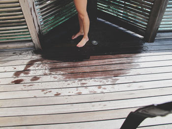 Woman under shower on beach