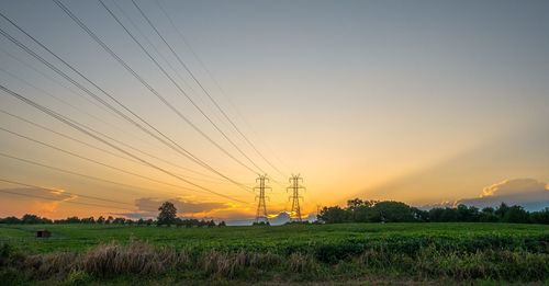 Scenic view of field against sky during sunset