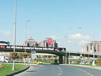 Road by city against clear sky