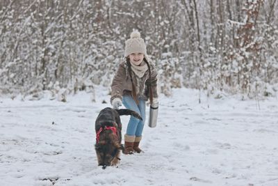 A girl with dog in snow