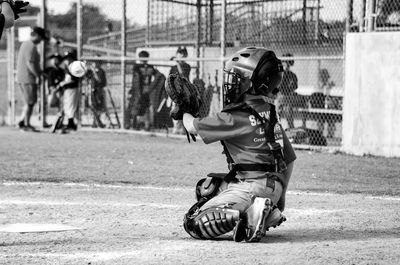 Full length of boy playing baseball on field