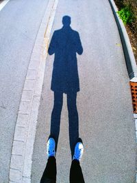 Low section of people standing on road