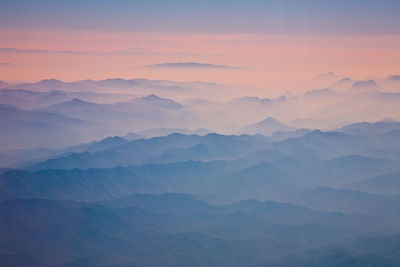 Scenic view of mountains against cloudy sky