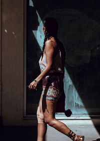 Woman standing by swimming pool