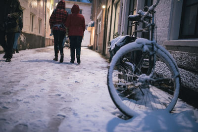 People on bicycle in city during winter