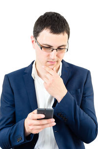 Young man using smart phone against white background