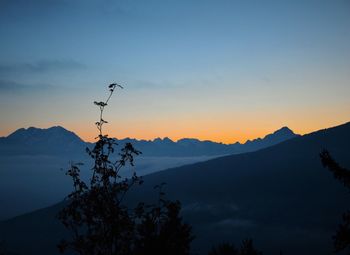 Scenic view of mountains against sky at sunset