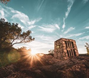 Abandoned building against sky during sunset