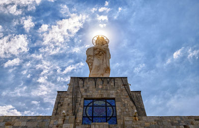 Low angle view of statue against sky