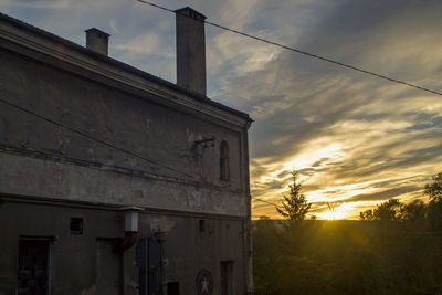 Low angle view of building against sunset sky